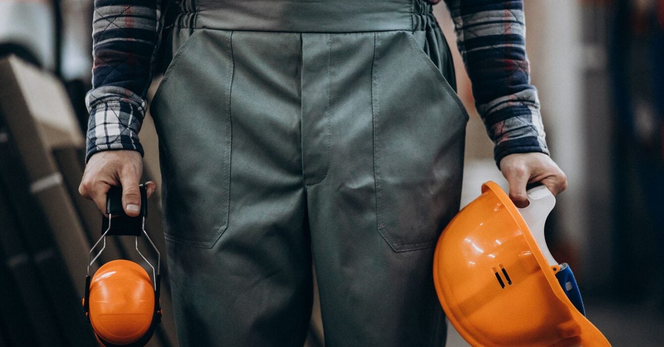 young-male-handyman-with-safety-earphones